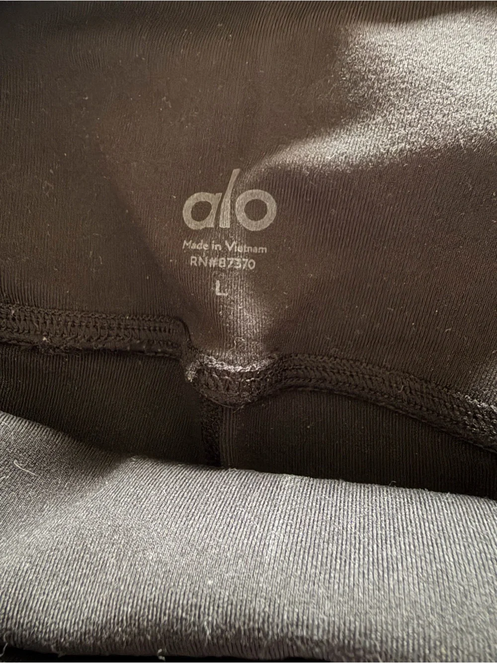 ALO Yoga Moto Leggings in a black and white